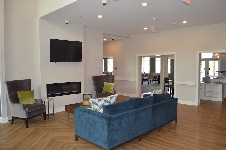 Common area seating around a modern fireplace and TV